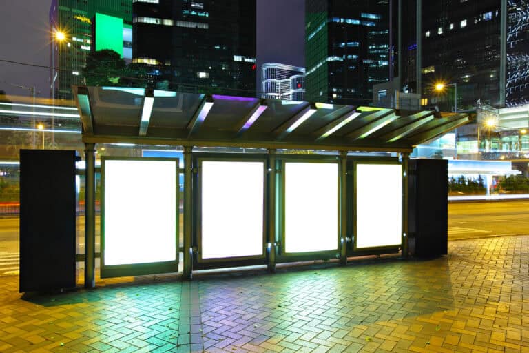 Blank billboard in city at night