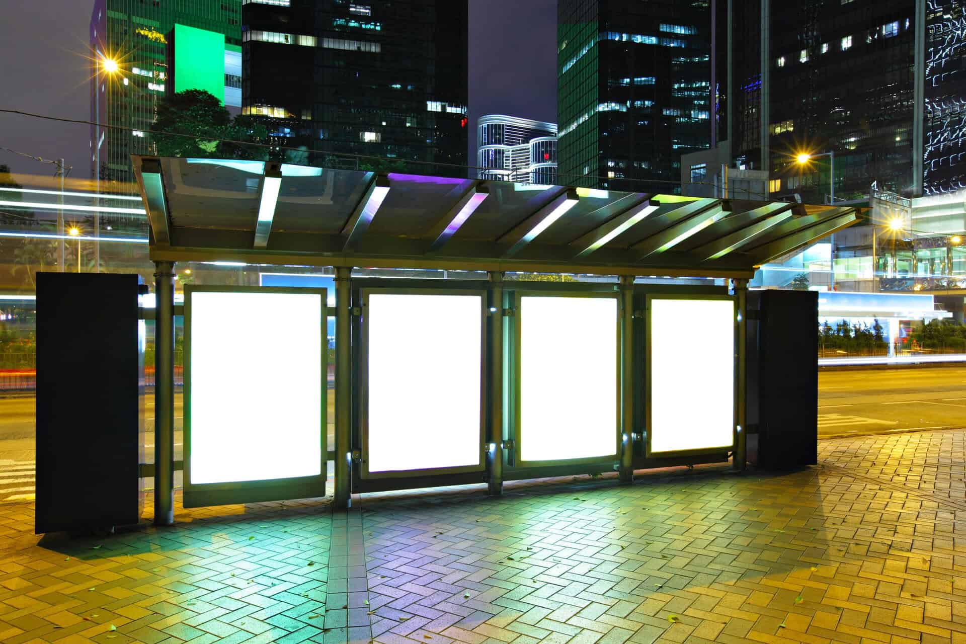Blank billboard in city at night